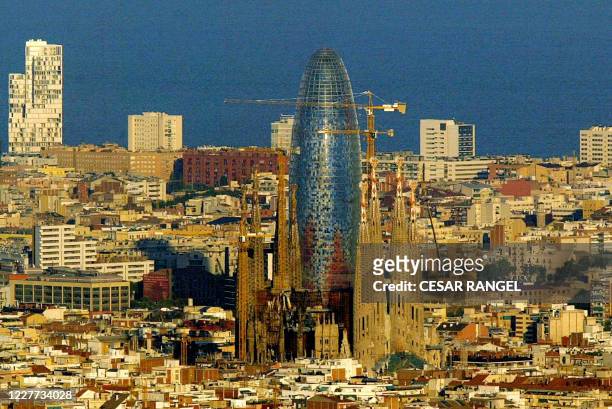 The Sagrada Familia of the architect Antoni Gaudi and the new Agbar Tower in Barcelona, 21 September 2005 following its inauguration by Spanish King...