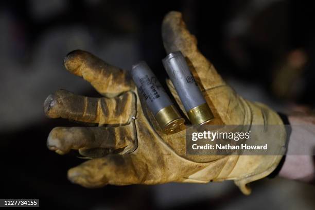Protester displays less-lethal shell casings after federal officers dispersed a crowd from in front of the Mark O. Hatfield U.S. Courthouse on July...