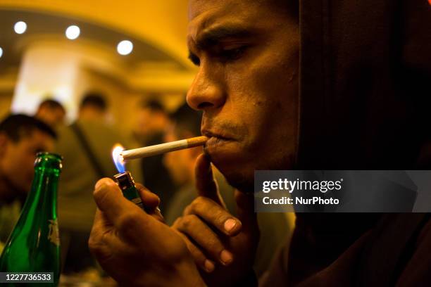 Tunis, Tunisia, 21 May 2015. A rapper lights a cigarette in a downtown bar.