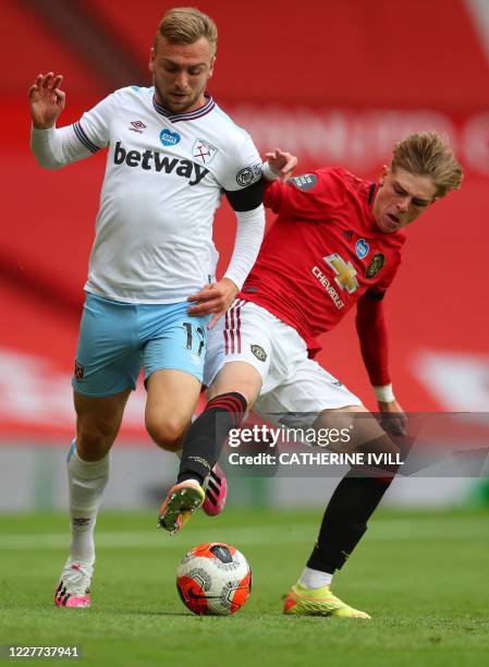Manchester United's English defender Brandon Williams challenges West Ham United's English striker Jarrod Bowen during the English Premier League...