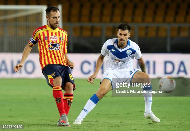 Marco Mancosu of Lecce competes for the ball with Daniele Desena of Brescia during the Serie A match between US Lecce and Brescia Calcio at Stadio...