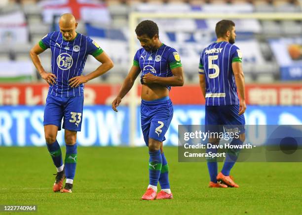 Dejected Wigan Athletic platers during the Sky Bet Championship match between Wigan Athletic and Fulham at DW Stadium on July 22, 2020 in Wigan,...