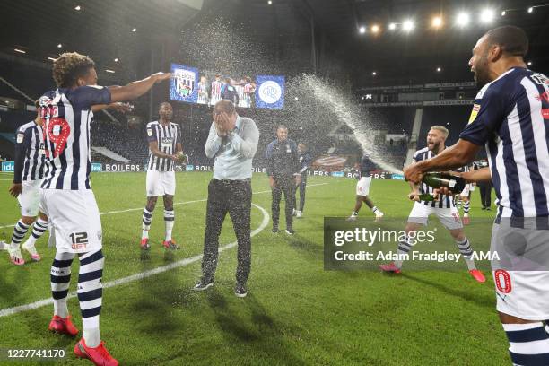 Champagne soaked Slaven Bilic head coach / manager of West Bromwich Albion as the team celebrate promotion to the Premier League on the pitch at the...