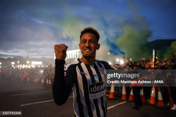 Callum Robinson of West Bromwich Albion celebrates with the fans outside as promotion to the Premier League is confirmed on the final day during the...