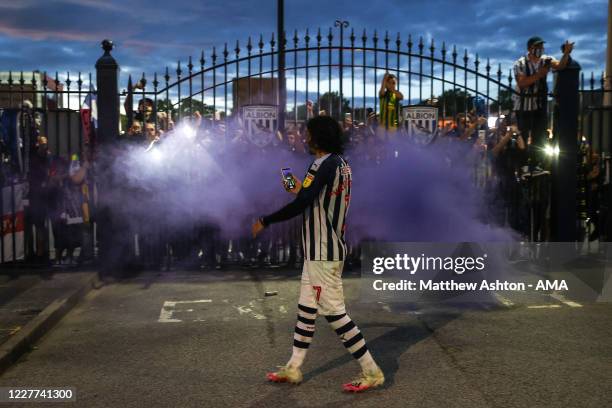 Filip Krovinovic of West Bromwich Albion celebrates with fans outside the stadium as promotion is confirmed to the Premier League is confirmed on the...