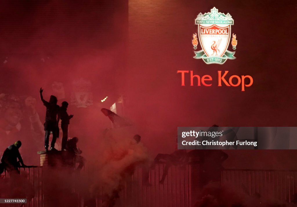 Fans Celebrate As Liverpool FC Lift The Premiership Trophy At Anfield