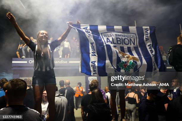 Fans of West Bromwich Albion celebrate outside the stadium as promotion to the Premier League is confirmed during the Sky Bet Championship match...