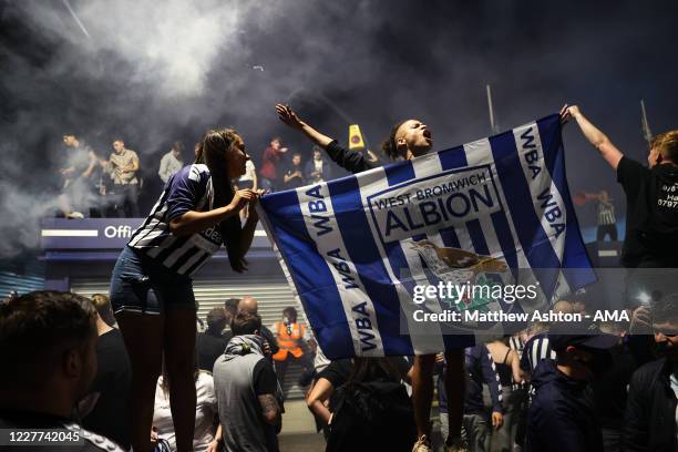 Fans of West Bromwich Albion celebrate outside the stadium as promotion to the Premier League is confirmed during the Sky Bet Championship match...