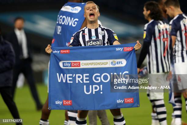 Kamil Grosicki of West Bromwich Albion celebrates promotion to the Premier League on the pitch at the end of the Sky Bet Championship match between...