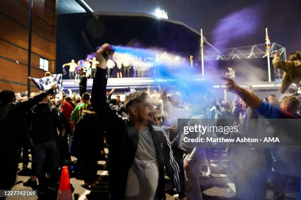 Fans of West Bromwich Albion celebrate outside the stadium as promotion to the Premier League is confirmed during the Sky Bet Championship match...