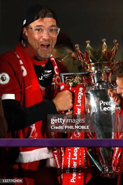 Liverpool's German manager Jurgen Klopp poses with the Premier League trophy during the presentation following the English Premier League football...