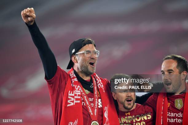 Liverpool's German manager Jurgen Klopp celebrates during the Premier League trophy presentation following the English Premier League football match...