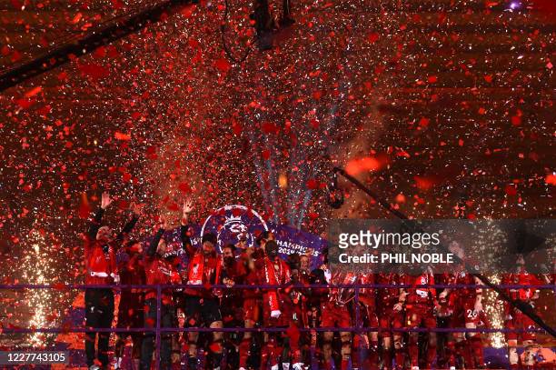 Liverpool's Egyptian midfielder Mohamed Salah holds the Premier League trophy during the presentation following the English Premier League football...