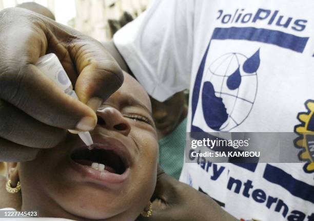 Ivory Coast nurse vaccinates a child against polio 25 February 2005 in Koumassi, a popular area of Abidjan. Ivory Coast health authorities launched a...