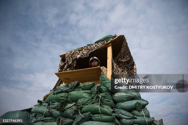 Marine from 1st Battalion, 8th Marines stands guard at his post at Musa Qala District Center base on February 1, 2011. AFP PHOTO / DMITRY KOSTYUKOV