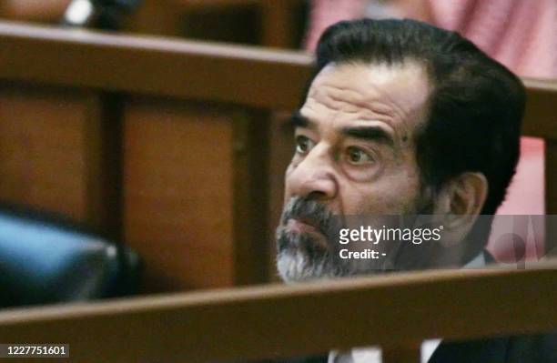 Ousted Iraqi leader Saddam Hussein listens during his trial to the prosecution giving his closing arguments in Baghdad, 19 June 2006. The trial of...