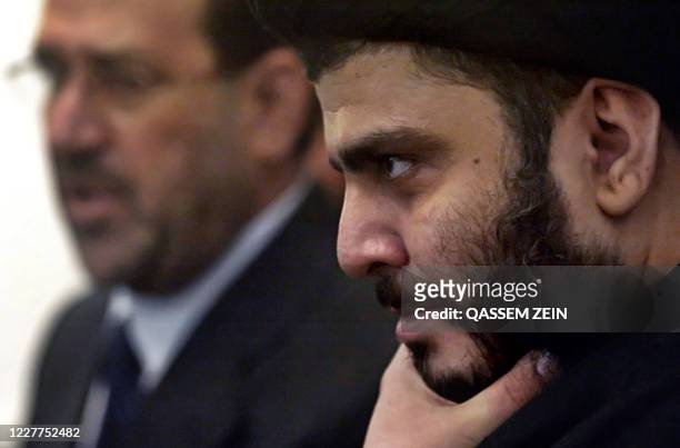 Shiite firebrand cleric Moqtada al-Sadr listens to a question during a joint press conference with Iraqi Prime Minister Nuri al-Maliki upon their...