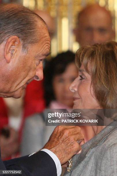 Le président Jacques Chirac félicite l'avocate Gisèle Halimi, élevée au grade d'officier de la Légion d'honneur, le 08 septembre 2006 au palais de...