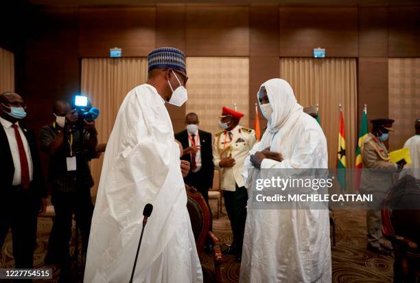 Nigeria's President Muhammadu Buhari and the Imam Mahmoud Dicko , influential leader of the opposition coalition, greet each other after a meeting in...