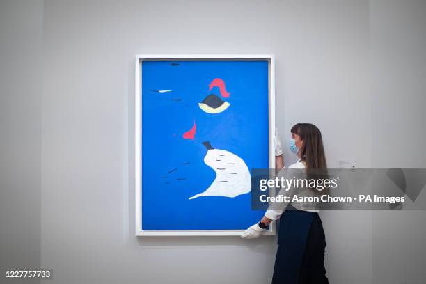 Gallery assistant next to Peinture by Joan Miro oil on canvas with an estimate of GBP 20-30 million during a press preview at Sotheby's in London...