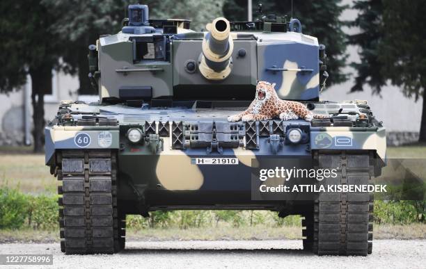 Stuffed toy leopard is placed on a Leopard 2/A4 battle tank during a handover ceremony of tanks at the army base of Tata, Hungary, on July 24, 2020....