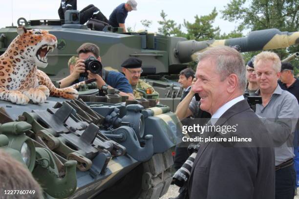 July 2020, Hungary, Tata: Tibor Benkö , Hungarian Minister of Defence, stands in front of the Leopard 2 A4 tanks delivered from Germany for training...