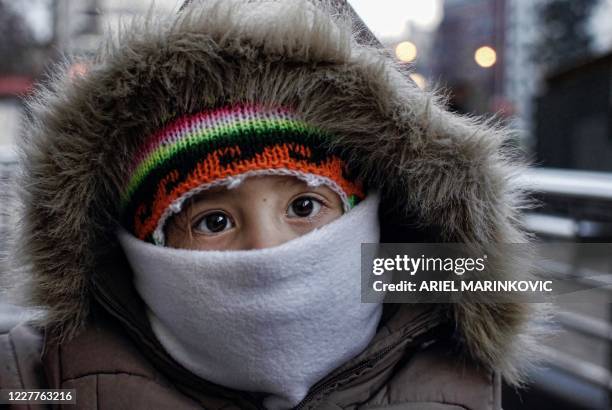 Boy with warm clothes in downtown Santiago July 21, 2010. Chile faces the coldest winter of the last three years, and has sustained losses that could...