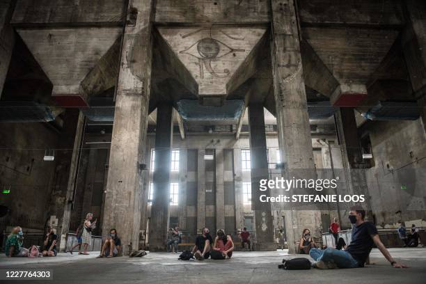 Visitors listen to the sound installation eleven songs halle am berghain at Berghain club in Berlin on July 24, 2020. - The sound installation of Sam...