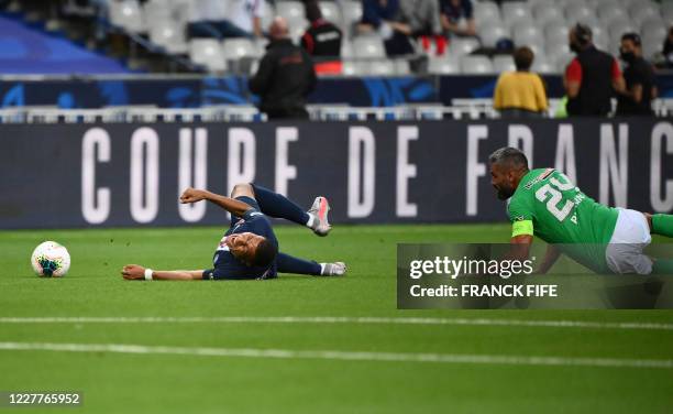 Paris Saint-Germain's French forward Kylian Mbappe reacts as he is fouled by Saint-Etienne's French defender Loic Perrin during the French Cup final...