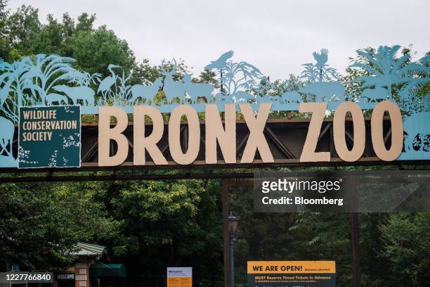 Sign reads "We Are Open!" at the entrance to the Bronx Zoo in the Bronx borough of New York, U.S., on Friday, July 24, 2020. On Monday, New York City...