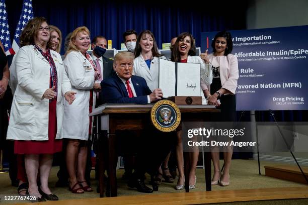 President Donald Trump signs executive orders on prescription drug prices in the South Court Auditorium at the White House on July 24, 2020 in...