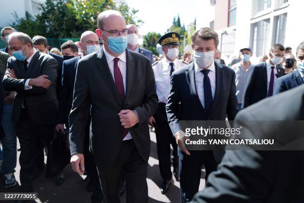 French Prime Minister Jean Castex, flanked by Nice mayor Christian Estrosi and French Justice Minister Eric Dupond-Moretti wearing protective mask,...
