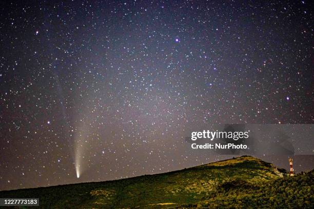 Comet NEOWISE at it's the closest distance with Earth, over the mountains near Toxotes town in Xanthi region Thrace and Nestos River in Northern...