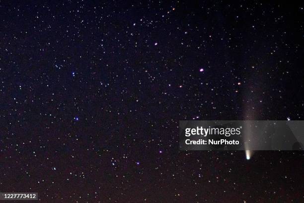 Comet NEOWISE at it's the closest distance with Earth, over the mountains near Toxotes town in Xanthi region Thrace and Nestos River in Northern...