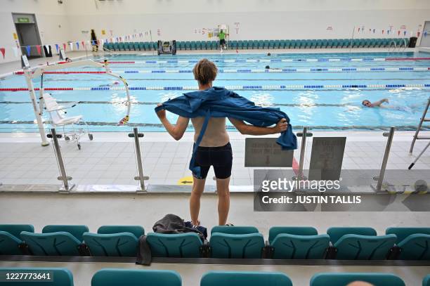 Swimmer dries themselves after swimming in the pool at Kensington Leisure Centre in west London on July 25, 2020 as novel coronavirus lockdown...