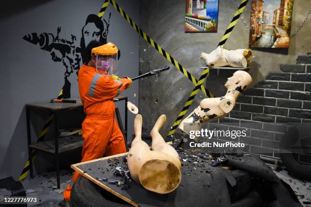 People take part in a &quot;Rage Room&quot; smashes a mannequin to vent anger and release stress in Bangkok, Thailand, 25 July 2020.