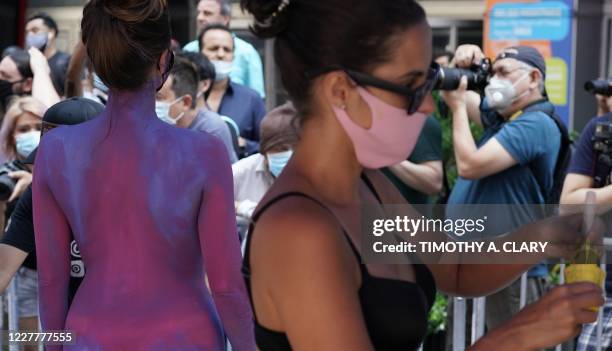 Woman gets her body painted during the 7th annual NYC Bodypainting Day in Times Square July 24, 2020 put on by artist artist Andy Golub and the Human...