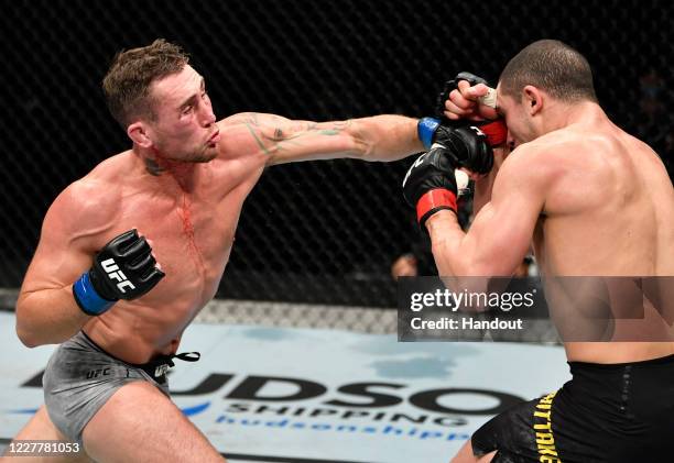 In this handout image provided by UFC, Darren Till of England punches Robert Whittaker of New Zealand in their middleweight fight during the UFC...