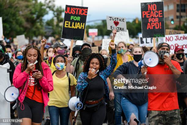 People march in the street to protest the death of Elijah McClain on July 25, 2020 in Aurora, Colorado. On August 24, 2019 McClain was walking home...
