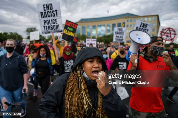 People march in the street to protest the death of Elijah McClain on July 25, 2020 in Aurora, Colorado. On August 24, 2019 McClain was walking home...