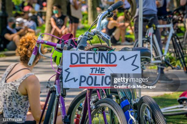 Member of Street Riders NYC carrying a Defund The Police sign. Thousands of New York activists participated in a massive march across the Brooklyn...