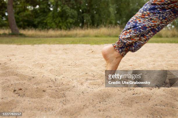 In this photo illustration a woman is walking without shoes on July 24, 2020 in Bonn, Germany.