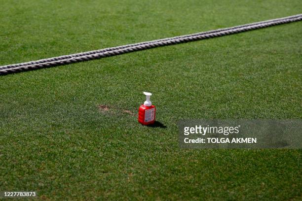 Bottle of hand sanitiser is seen beyond the boundary rope on the pitch during the friendly county cricket match between Surrey and Middlesex at the...