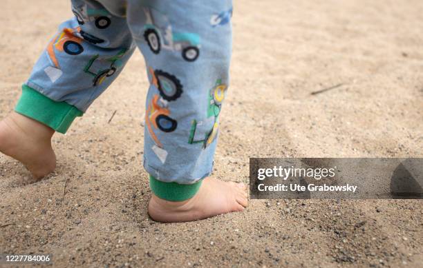 In this photo illustration a toddler is walking without shoes on July 24, 2020 in Bonn, Germany.