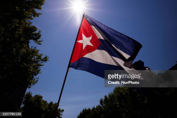 Protesters with Cuban flags during the demonstration with the slogan 'Cuba saves lives: 60 years of internationalism' for July 26, the day of Cuba's...