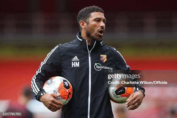 Watford caretaker manager Hayden Mullins oversees the warm-up before the Premier League match between Arsenal FC and Watford FC at Emirates Stadium...