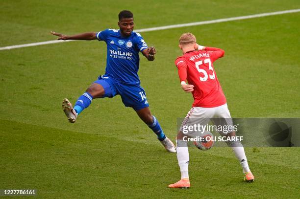 Leicester City's Nigerian striker Kelechi Iheanacho and Manchester United's English defender Brandon Williams challenge for the ball during the...