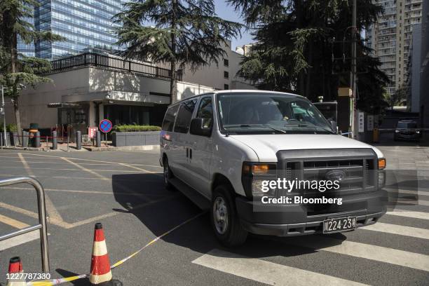 Vehicle with diplomatic plates drives out from the U.S. Consulate General Chengdu in Chengdu, China, on Sunday, July 26, 2020. The closure of the...