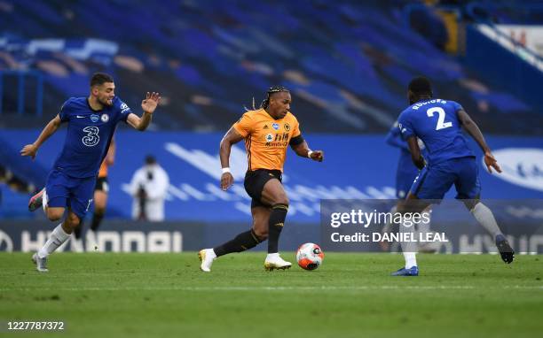 Chelsea's Croatian midfielder Mateo Kovacic and Chelsea's German defender Antonio Rudiger close in on Wolverhampton Wanderers' Spanish midfielder...