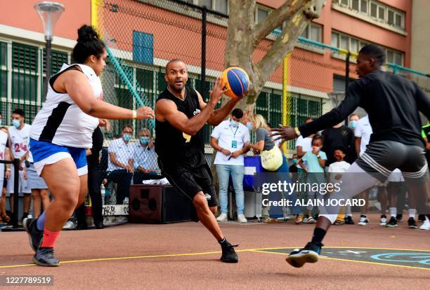 Former French basketball player Tony Parker plays the ball with Club Paris 2024 members as part of the Club Paris 2024-defi Tony Parker on July 26 in...